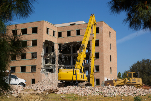 Commercial Demolition Project with a big yellow crane