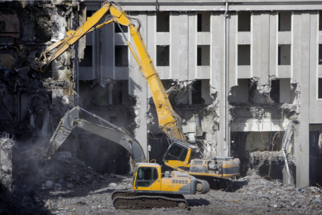 Building Demolition with 2 big yellow cranes